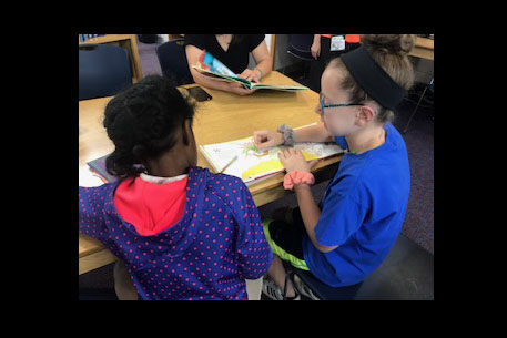 Krieger Schechter sixth-grader Lea G. reads with her buddy, a first-grade student at Dorothy I. Height Elementary School