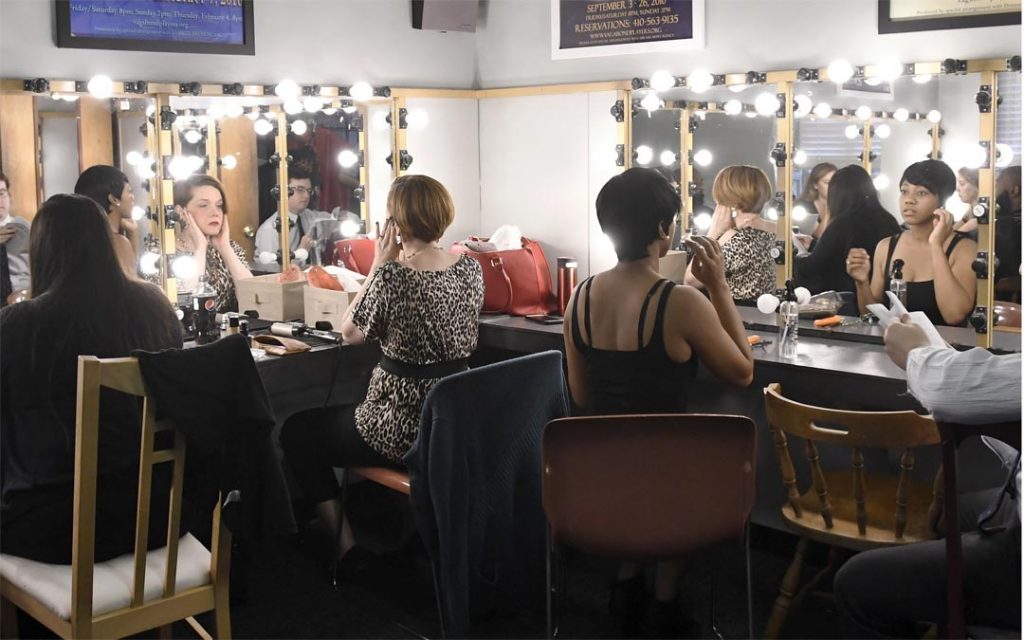 Members of the cast of Vagabond Players’ “Twelve Angry Jurors” prepare for a photo shoot.