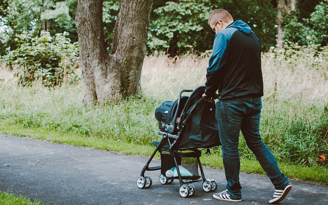 Father pushing stroller (Photo by Lisa Fotios from Pexels)