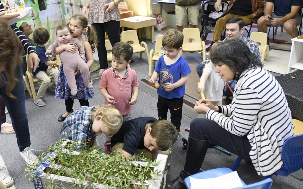 Children create a small sukkah during the "Sukkot Under the Stars" event at Beth El preschool in Federal Hill. (Photo by Steve Ruark)