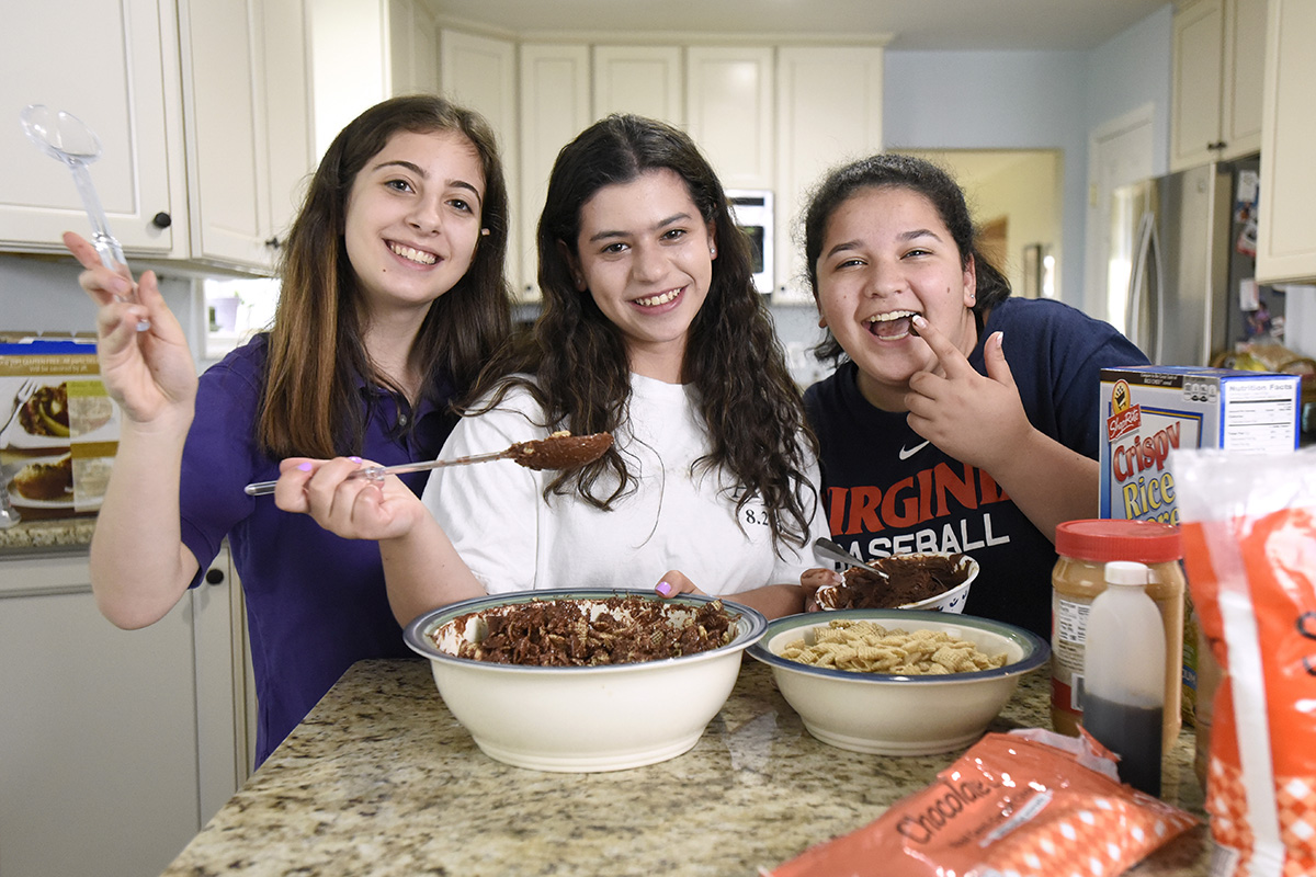 From left, Ariella Kovacs, 15, a Beth Tfiloh student, Tali Gheiler, 15, a Jemicy School student, and Gal Evgey, 14, a Beth Tfiloh student, bake at Kovacs' Pikesville home. Together, they started Delicious Desserts, a business through which they sell their baked goods.