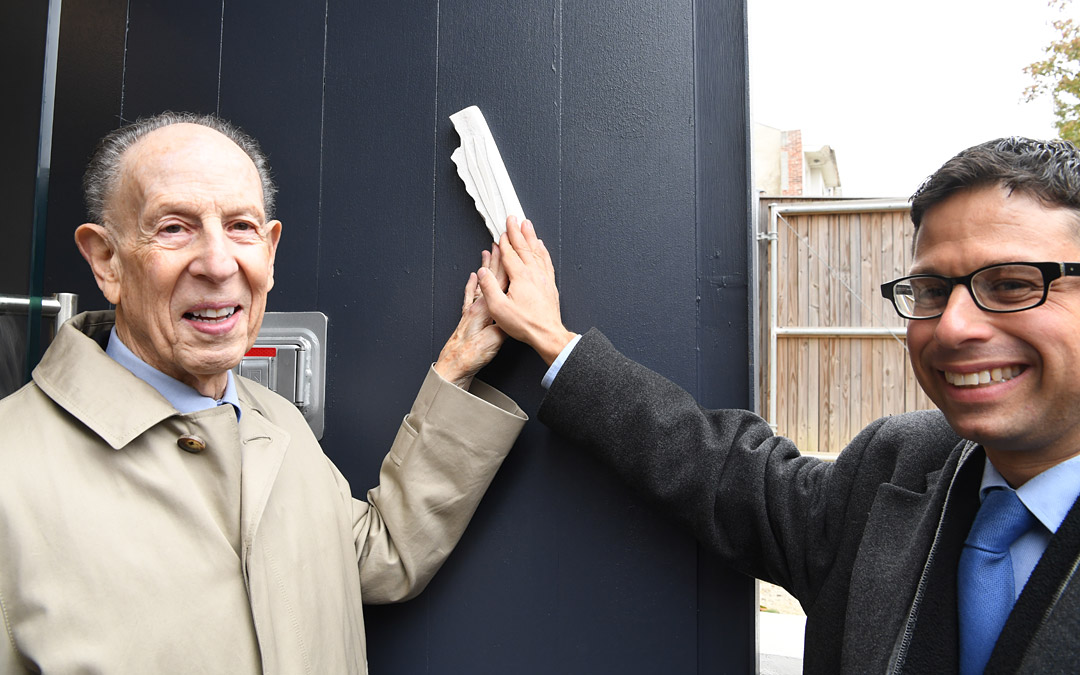 Beth Am congregant and benefactor Mark Joseph (left) and Rabbi Daniel Cotzin Burg participate in the mezuzah-affixing ceremony. (Photo by Jim Burger)ededication ceremony concluded with the affixing of a mezuzah at the grand entrance of the nearly century-old building. (Photo by Jim Burger)