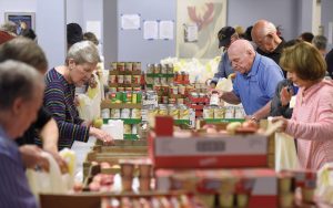 An estimated 60 to 70 volunteers help assemble backpacks full of food every Thursday morning at the makeshift warehouse of Weekend Backpacks for Homeless Kids at 1505 Bedford Ave. in Pikesville. (Photo by Steve Ruark)