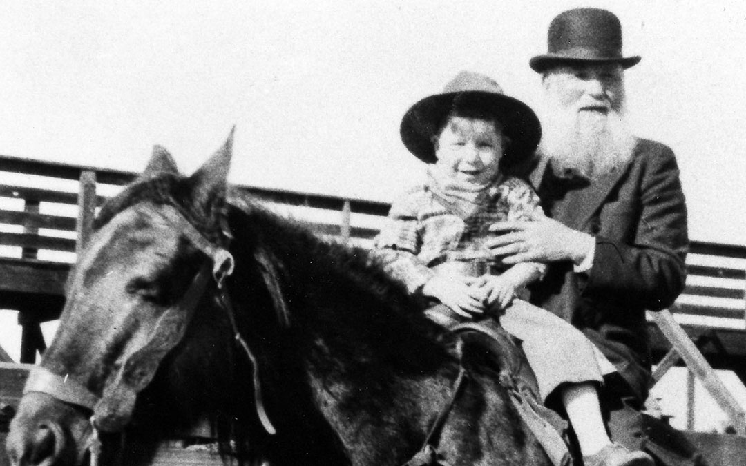 Lithuanian-born rancher and cattle baron Robert Lazar Miller is shown on horseback with his grandson, Stanley Stein, at the Denver Stockyards, circa 1932. (Beck Archives, Special Collections, University of Denver Libraries)