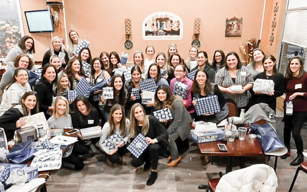 On Dec. 3, or “Giving Tuesday,” 37 women from JVC Moms on a Mission, led by Laurie Rosen, wrapped gifts for families being helped by Shalom Tikvah. (Photo provided by Talya Knable)