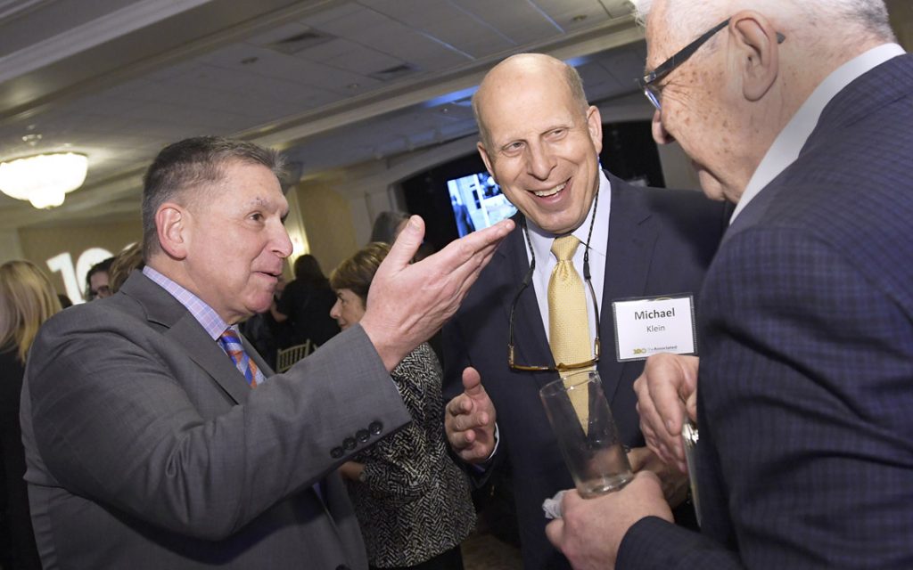Marc B. Terrill, left, president and CEO of The Associated, chats with Michael Klein, center, and Dick Dahan, during the organization's Centennial Campaign kickoff. (Photo by Steve Ruark)