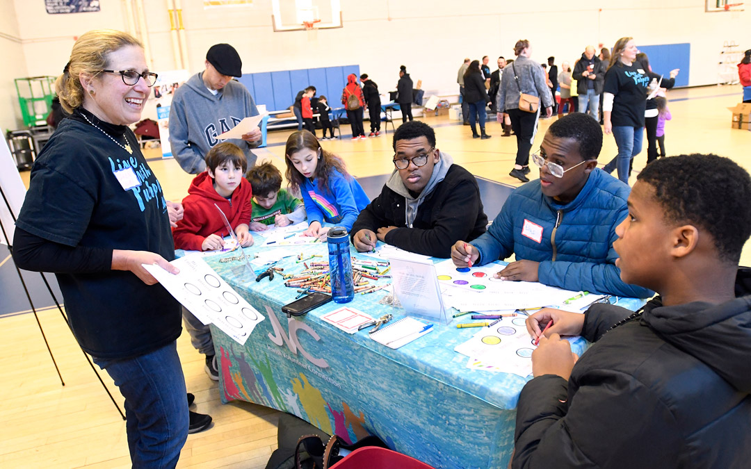 Jewish Volunteer Connection (JVC) board member Karen Singer, left, leads volunteers in making flashcards for the Esperanza Center and Maree G. Farring Elementary School during JVC's Martin Luther King Day Jr. Day of Service program at the Weinberg Park Heights Jewish Community Center. (Photo by Steve Ruark)