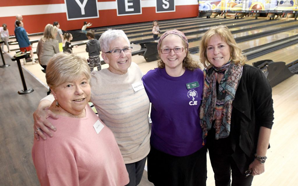Gabriella Burger, third from left, director of Jewish educational engagement for the Macks Center for Jewish Education, stands with Ellen Stein, left, of Mount Washington, Margi Hoffman, second from left, of Pikesville, and Ann Abramson of Pikesville, all connectors for the Saba-ba: Grandparents on the Go party, during a launch party at AMF Pikesville Lanes. The Saba-ba program brings together children and their grandparents. (Photo by Steve Ruark)