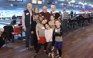 Back row, from left, Gil Abramson, Ann Abramson, Robert Mankin and Vivian Mankin stand with their grandchildren during the Macks Center for Jewish Education's Saba-ba: Grandparents on the Go launch party at AMF Pikesville Lanes. (Photo by Steve Ruark)
