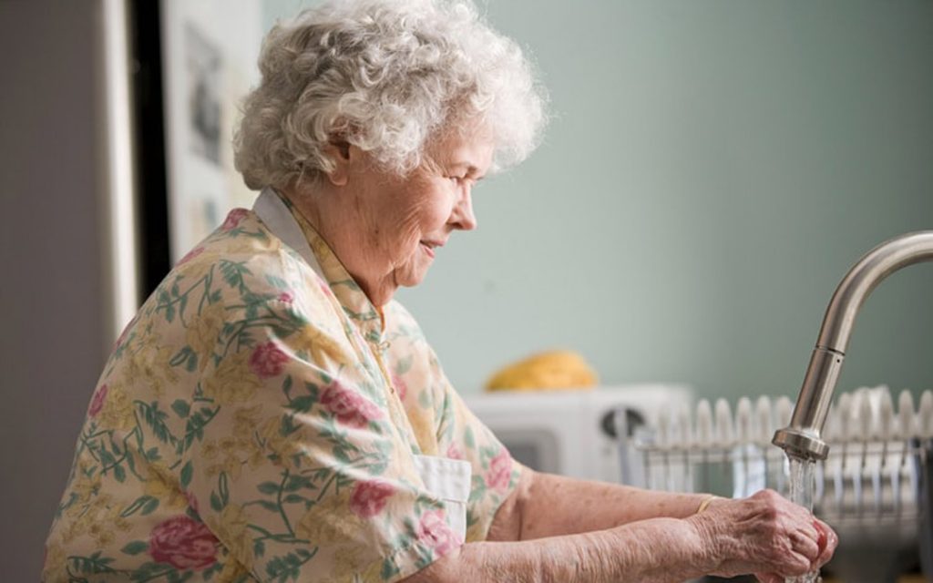Older woman washing hands