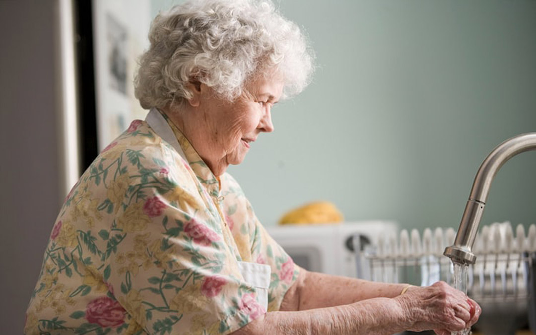 Older woman washing hands