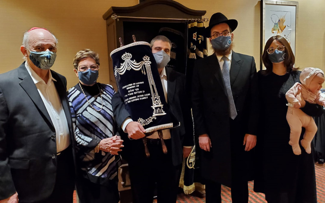 Chabad of Downtown celebrates the arrival of the Harold Jeter Torah. (Left to right) Avron Lewin, Jacqui Juter, Elton Juter, Rabbi Levi Druk and Chani Druk. (Photo by Naftali Druk, Chabad of Downtown)