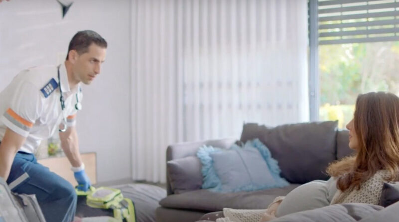 A paramedic with Magen David Adom, Israel's national emergency medical service, treats a pregnant woman in her home.