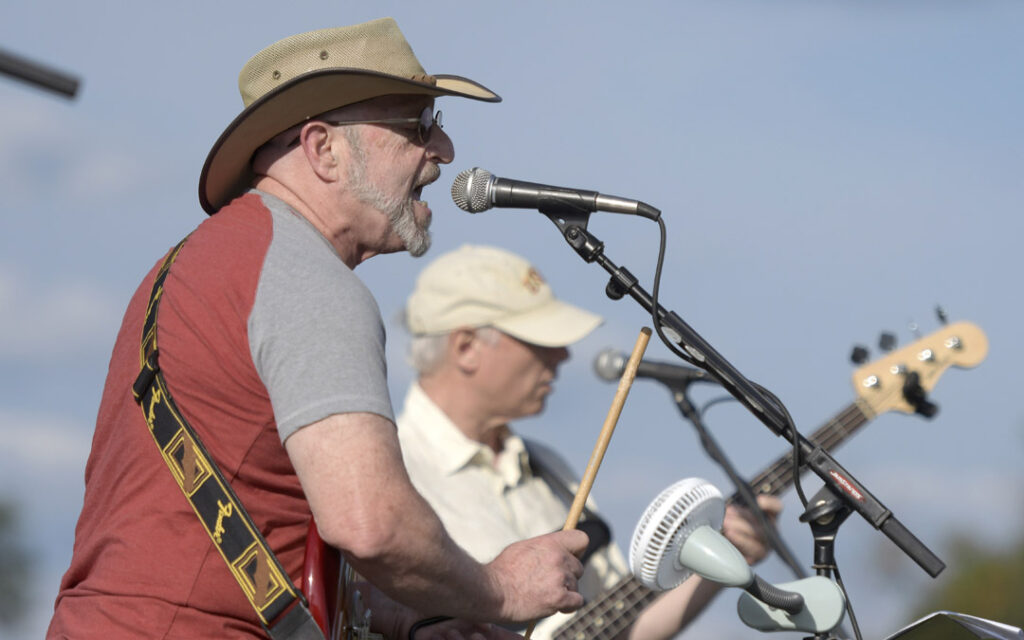 Dave Meer, left, and Jon Book perform with their band, Shrink the Deficit, during Chizuk Amuno Congregation's SummerFest.