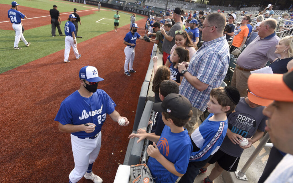 Team Israel pitcher Benny Wanger signs autographs before an exhibition game against the Cal Ripken Collegiate All-Stars in Aberdeen. (Photo by Steve Ruark)