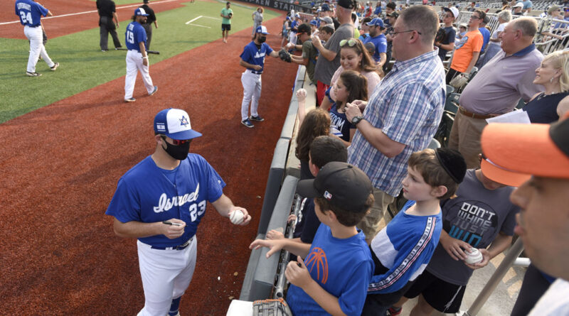 Team Israel pitcher Benny Wanger signs autographs before an exhibition game against the Cal Ripken Collegiate All-Stars in Aberdeen. (Photo by Steve Ruark)