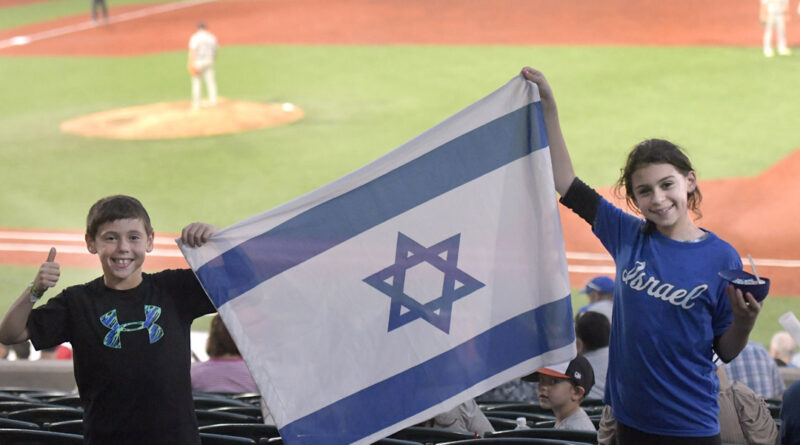 Eli Berkovich, 9, and his sister, Rena, 12, of Pikesville, support Team Israel during an exhibition game against the Cal Ripken Collegiate All-Stars in Aberdeen. (Photo by Steve Ruark)