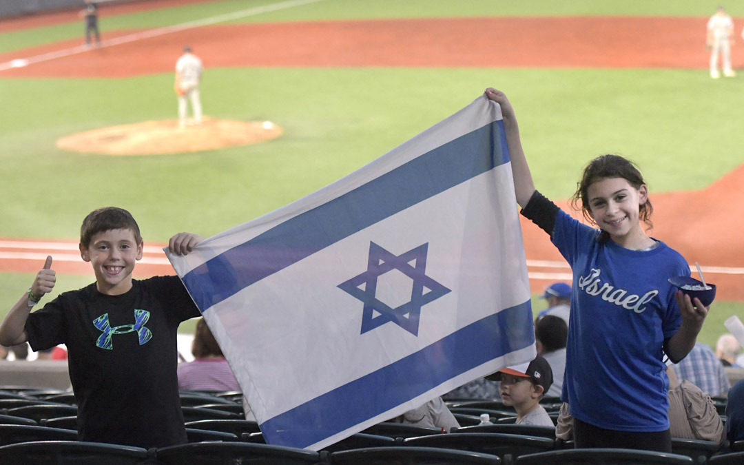 Eli Berkovich, 9, and his sister, Rena, 12, of Pikesville, support Team Israel during an exhibition game against the Cal Ripken Collegiate All-Stars in Aberdeen. (Photo by Steve Ruark)