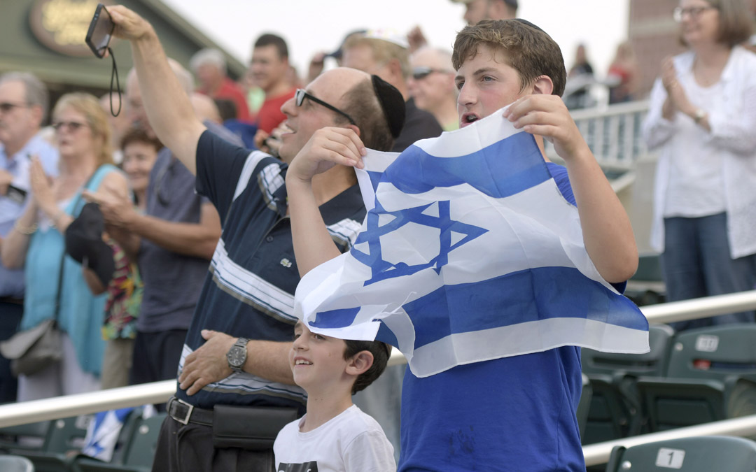 From left, Philippe Lerner, of Baltimore, and his sons, James, 7, and Jacky, 14, attend an exhibition baseball game between Team Israel and the Cal Ripken Collegiate All-Stars in Aberdeen. (Photo by Steve Ruark)