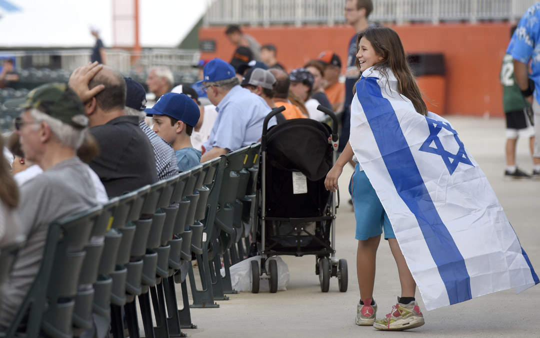Ora Goldman, who was visiting from Los Angeles, supports Team Israel during an exhibition baseball game against the Cal Ripken Collegiate All-Stars in Aberdeen. (Photo by Steve Ruark)
