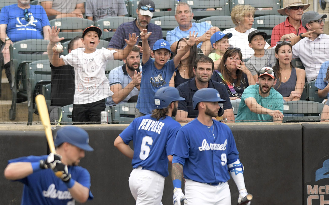Fans cheer after Team Israel's Zach Penprase (#6) scores a run in an exhibition game against the Cal Ripken Collegiate All-Stars in Aberdeen. (Photo by Steve Ruark)