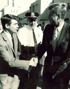 A young Ted Venetoulis is shown here shaking the hand of President John F. Kennedy