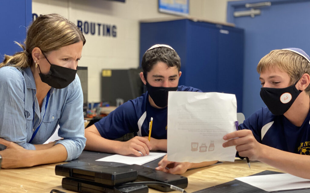 Middle School science teacher Krista Maniatis guides BT eighth graders through a logo design project.