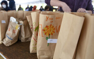 Volunteers pack lunches for people facing food insecurity during Posner JEM Religious School's family education event to support JVC's Bunches of Lunches program.