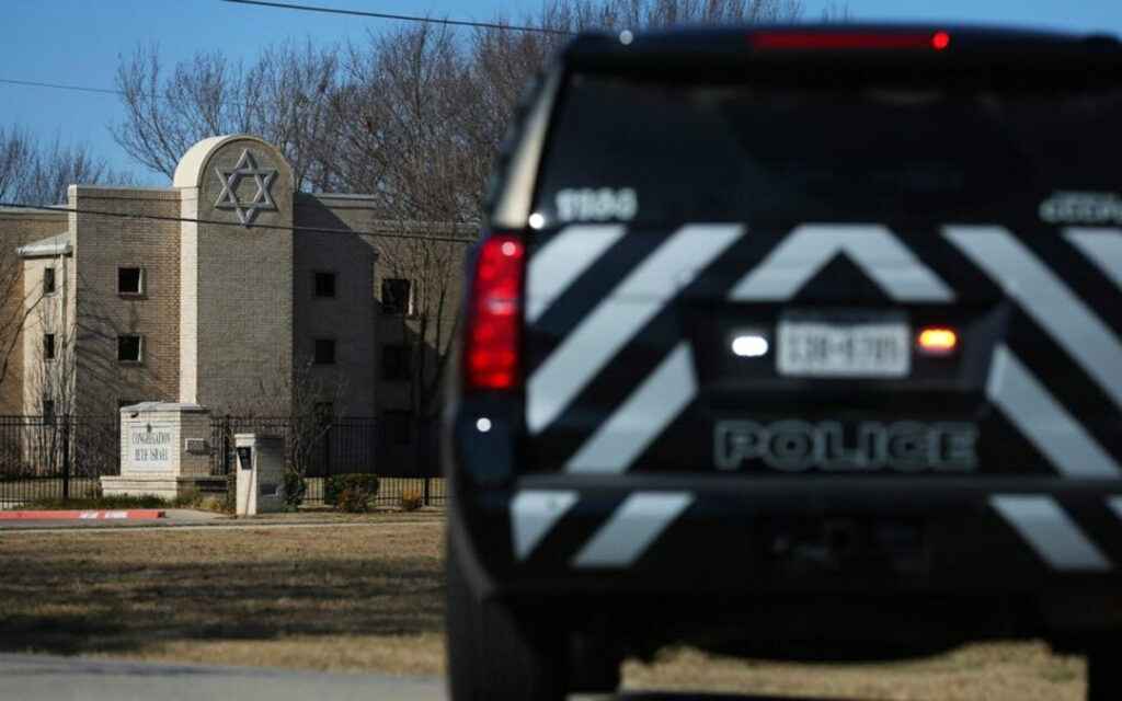 A police vehicle sits outside of the Congregation Beth Israel Synagogue in Colleyville, Texas