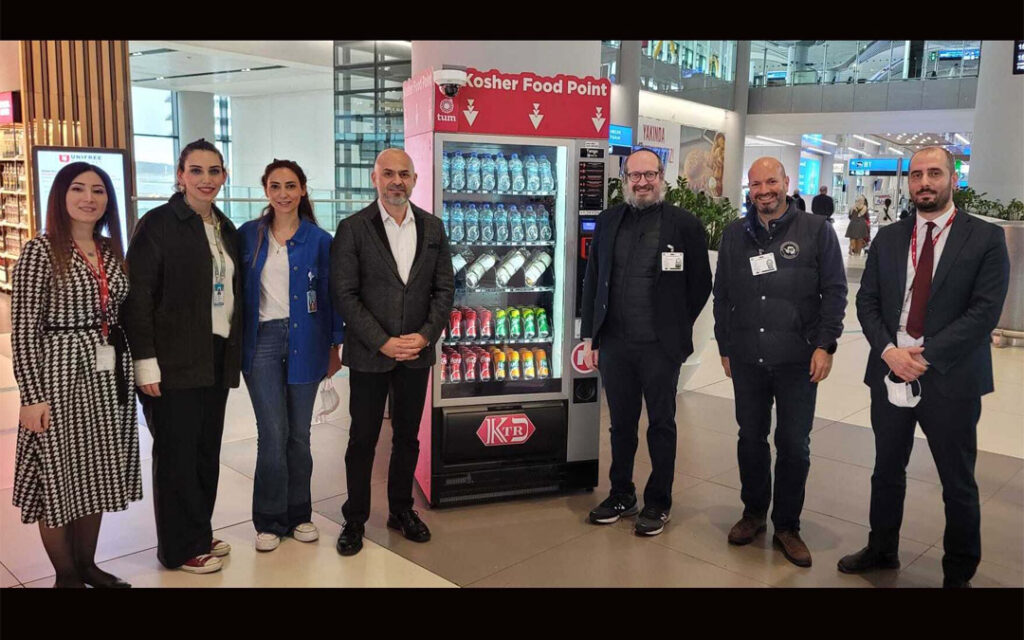 Rabbi Mendy Chitrick stands third from right next to the Istanbul Airport's new kosher vending machine.