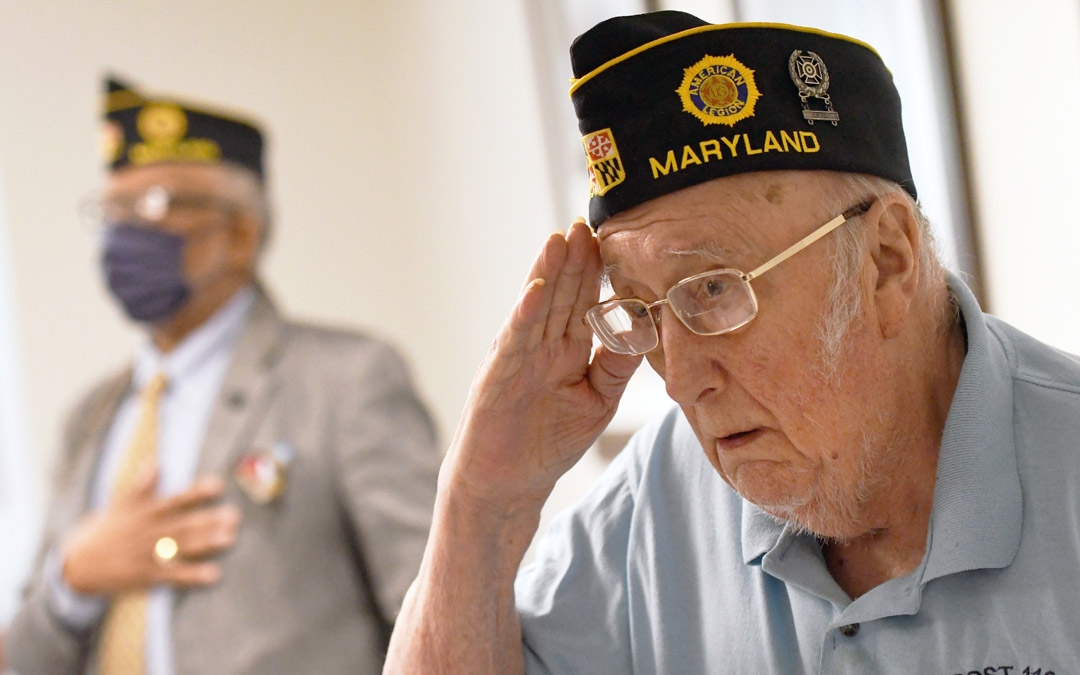 Lew Gross, who served in the U.S. Army in the 1960s, salutes during the reciting of the Pledge of Allegiance.