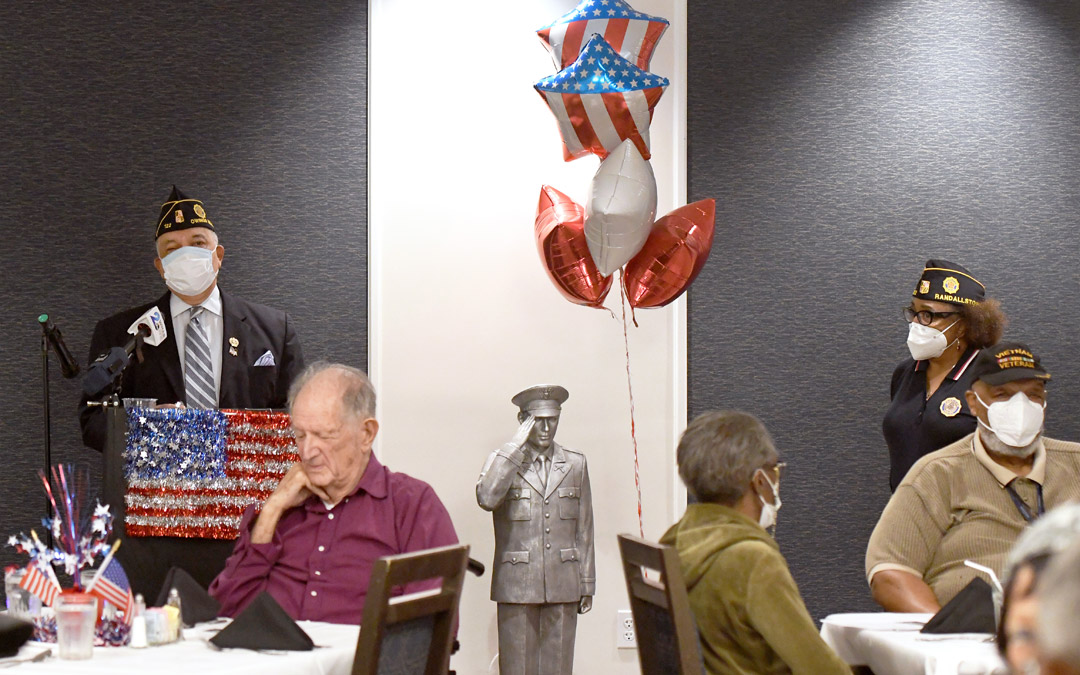 U.S. Army veteran Ed Jackson (left) speaks during the Memorial Day luncheon at Atrium Village senior community.