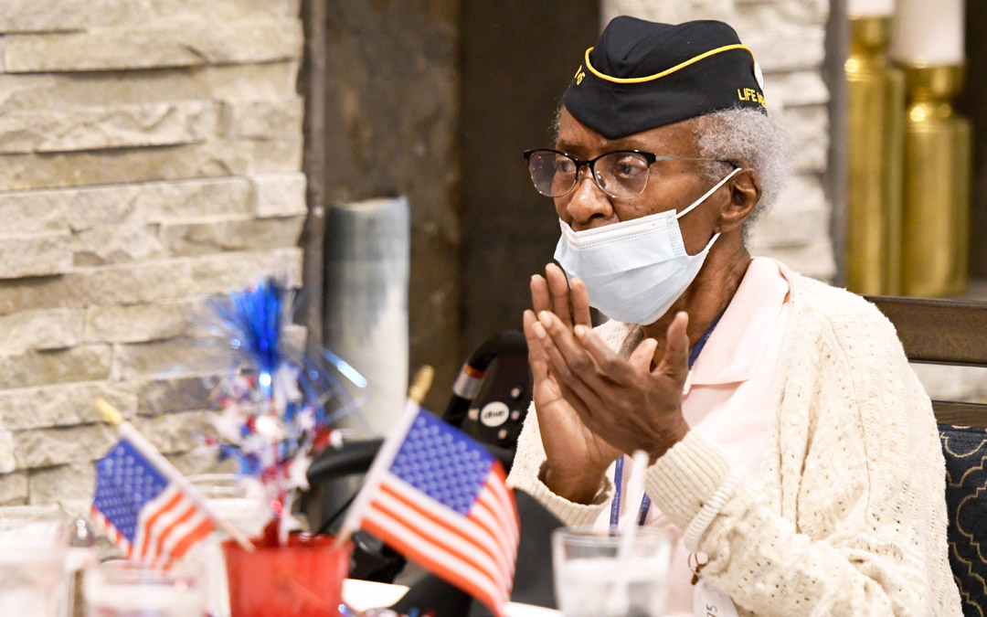 U.S. Air Force and Vietnam War veteran Sallie Smith applauds during the program.