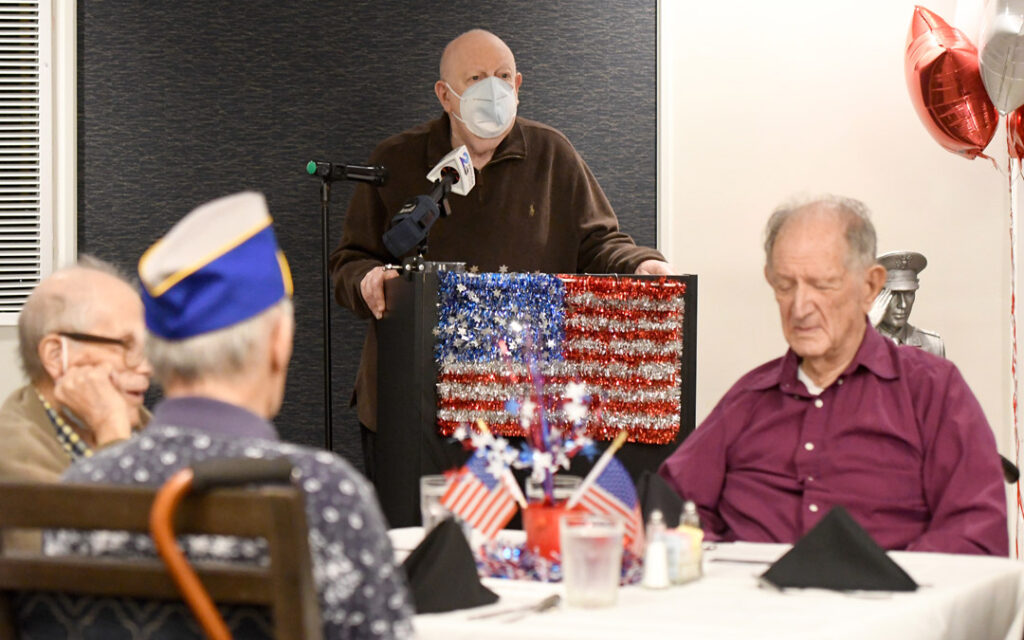 Irv Eberlin, a veteran of the Maryland Army National Guard, sings a patriotic song during the luncheon.