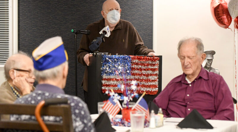 Irv Eberlin, a veteran of the Maryland Army National Guard, sings a patriotic song during the luncheon.