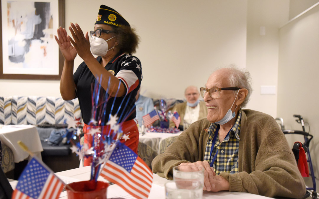 Army veteran Vanessa Deal (left), service officer with American Legion Post 122, and U.S, Air Force veteran David Rosenberg, cheer on one of the honorees.