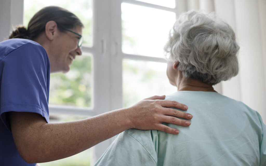 nurse taking care of older woman