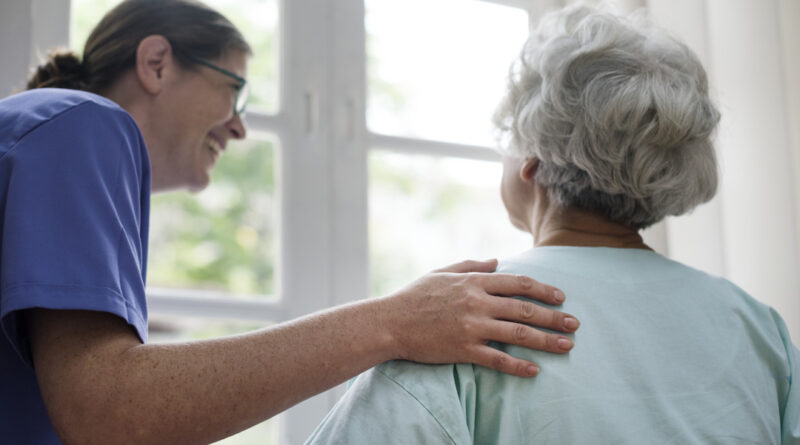 nurse taking care of older woman