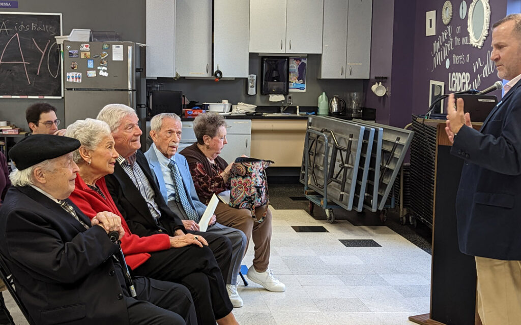 Barak Hermann (far right), chief executive officer of the JCC of Greater Baltimore, speaks to members and supporters of the JEA Fellowship Association.