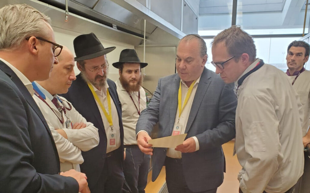 Rabbi Marc Schneier, holding paper, and Rabbi Mendy Chitrik, third from left, worked together on the initiative.