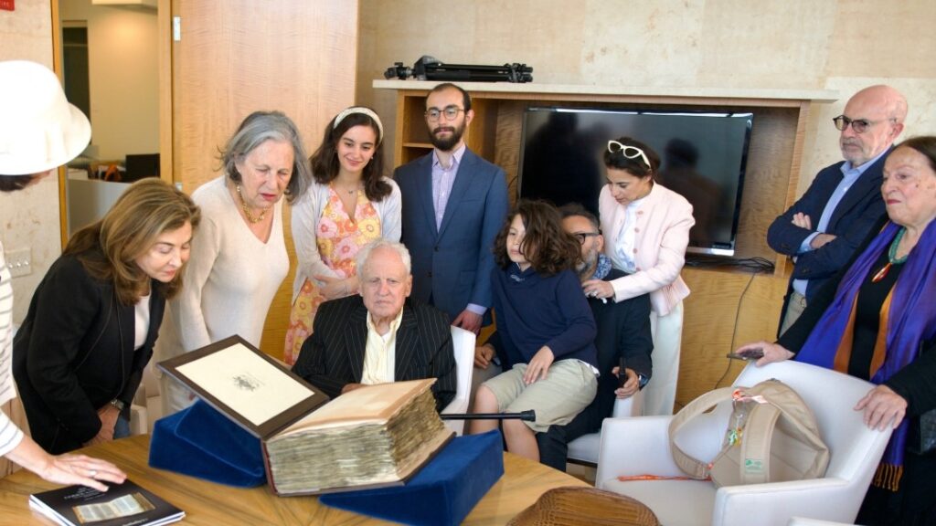 Alfred Moses examines the Codex Sassoon surrounded by family and friends