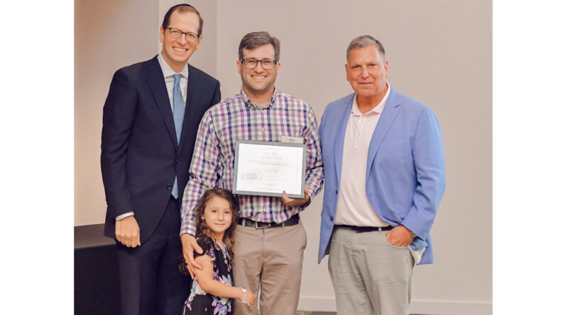 Mike Fuld (center, with daughter) is flanked by Yehuda Neuberger (left) and Marc B. Terrill.