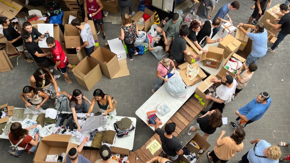 Donors are bringing clean clothes, mobile phone batteries, dry food and other products to volunteer collection points like this one in Modiin, Israel.