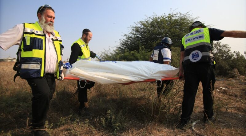 Medical responders carry a body bag in Sderot, Israel, Oct. 8