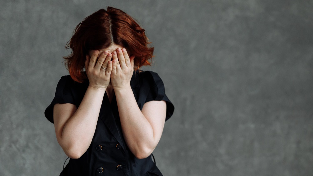 woman with head in hands