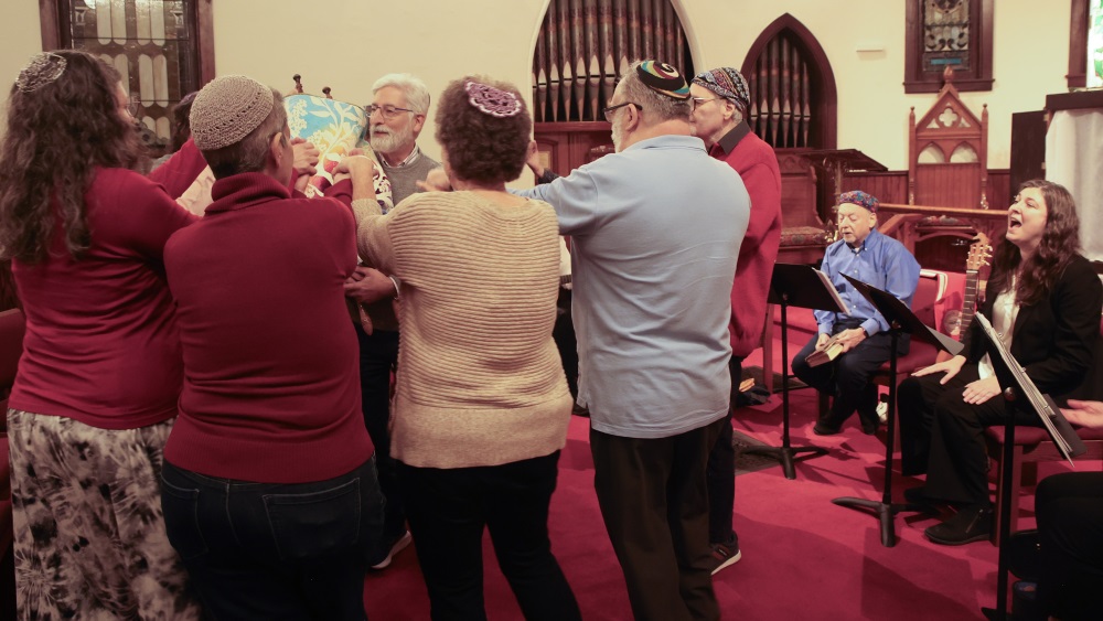 Jonathan Lowenberg holds the Torah