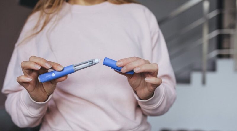 A woman prepares a semaglutide pen