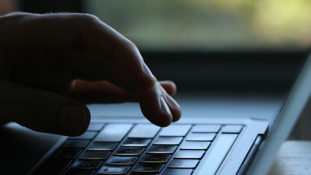 hand at computer