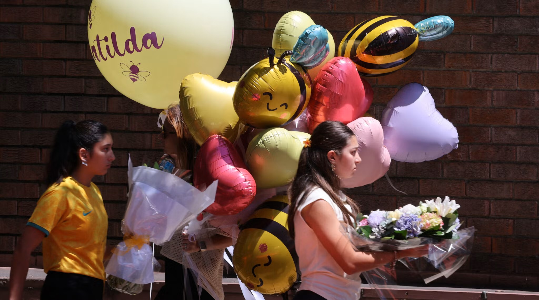 People carry balloons as they arrive for the funeral of 10-year-old Matilda, who was killed in the Dec. 14 Bondi Beach shooting attack in Sydney.