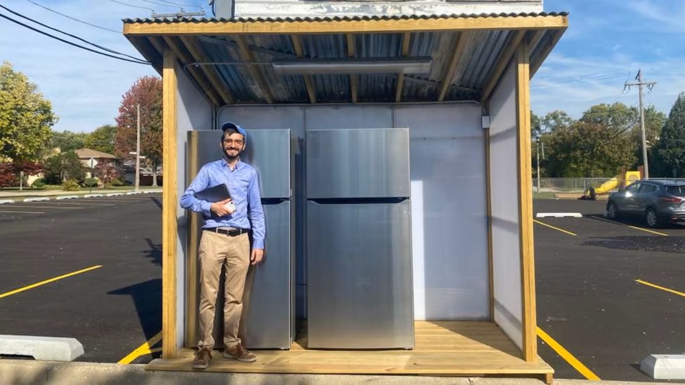 Rabbi Hody Nemes (far left) stands in front of Hersh’s Fridge, a community fridge that serves kosher-keeping Jews in the Chicago area.